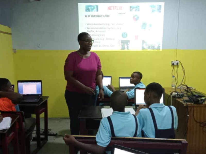 A Nibi's Tech instructor leading a weekly class with students working on laptops