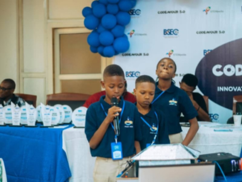 A student presenting his team's project into a microphone at a competition