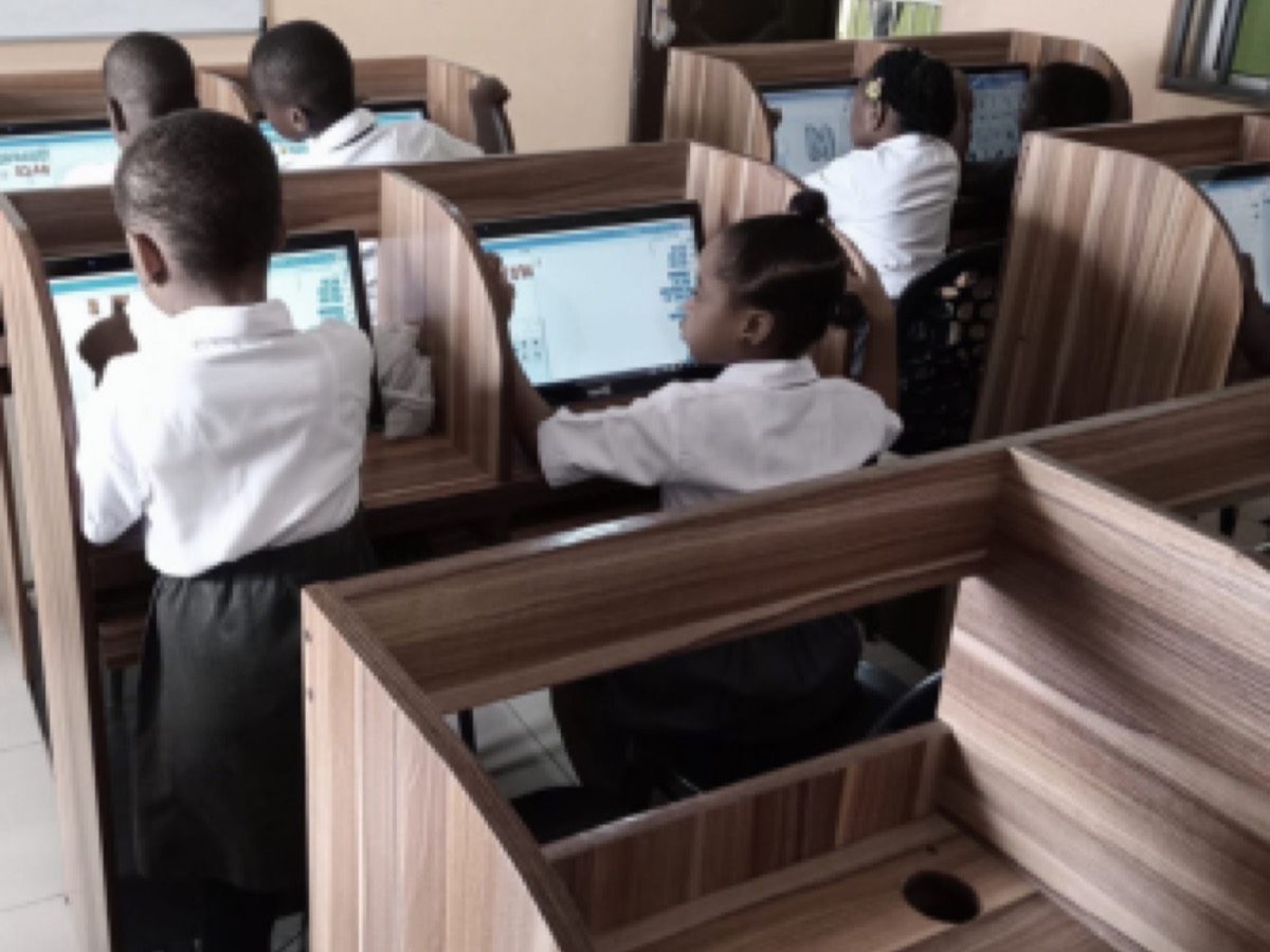 Students working through a coding exercise at computers in the lab